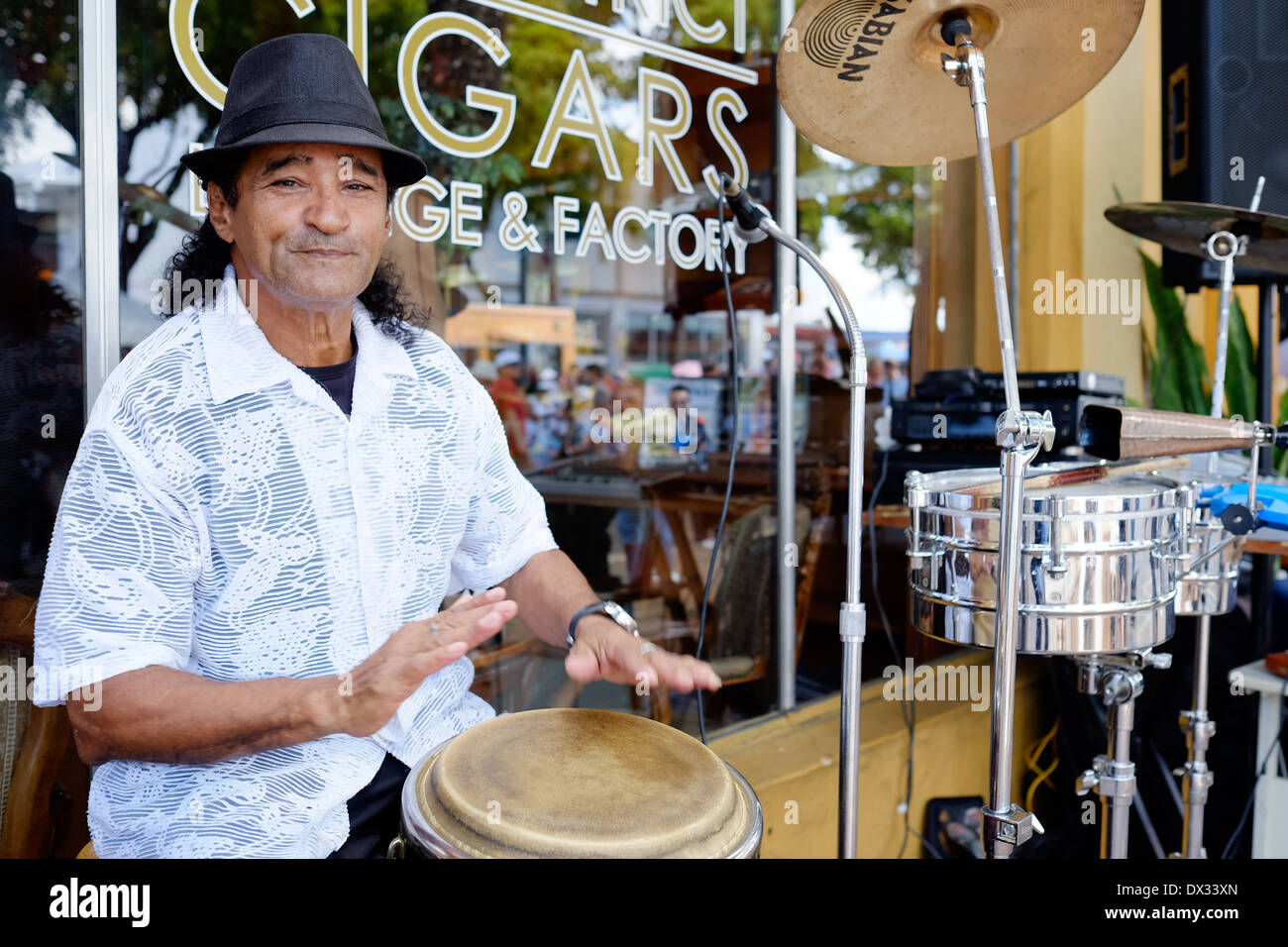 MIAMI - MARCH 9, 2014: Portrait of musician with drums during the 37th Calle Ocho festival, an annual event that takes place over Eight Street in Little Havana featuring plenty of music, food, and  it is the biggest party in town that celebrates hispanic heritage. Stock Photo