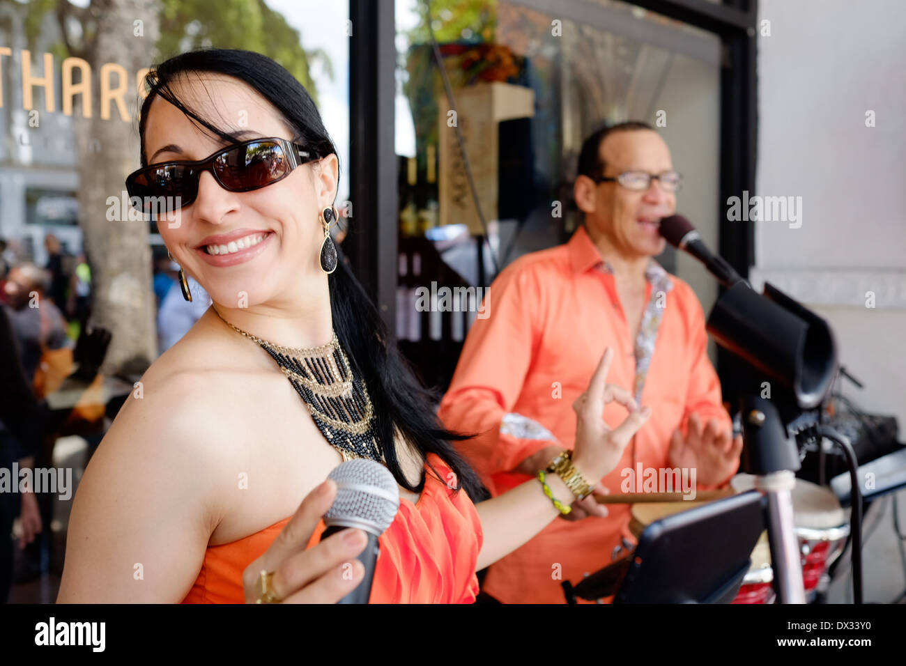 MIAMI - MARCH 9, 2014: Portrait of woman singing and dancing during the 37th Calle Ocho festival, an annual event that takes place over Eight Street in Little Havana featuring plenty of music, food, and  it is the biggest party in town that celebrates hispanic heritage. Stock Photo