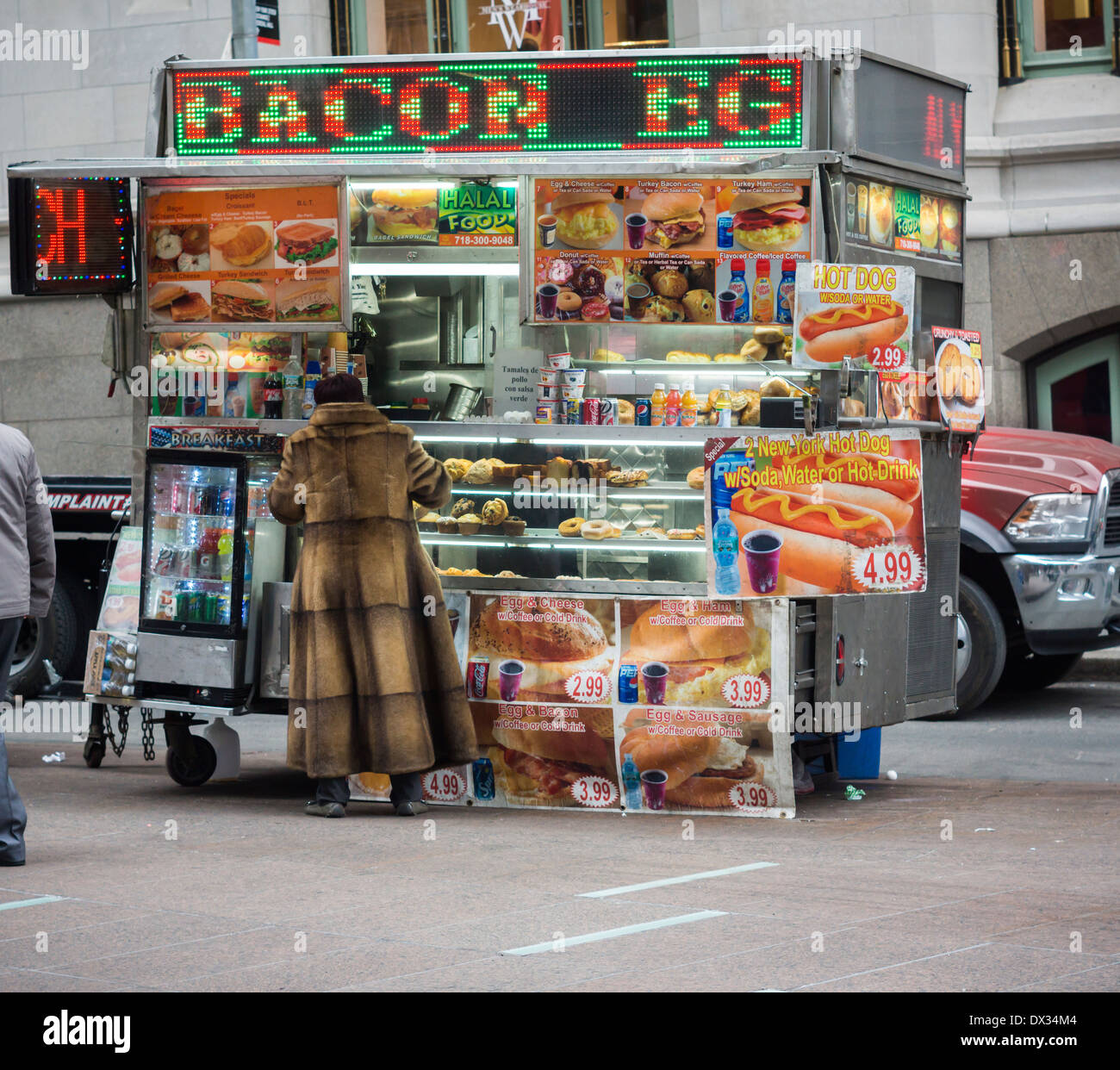 A halal food cart in Lower Manhattan in New York advertises its bacon