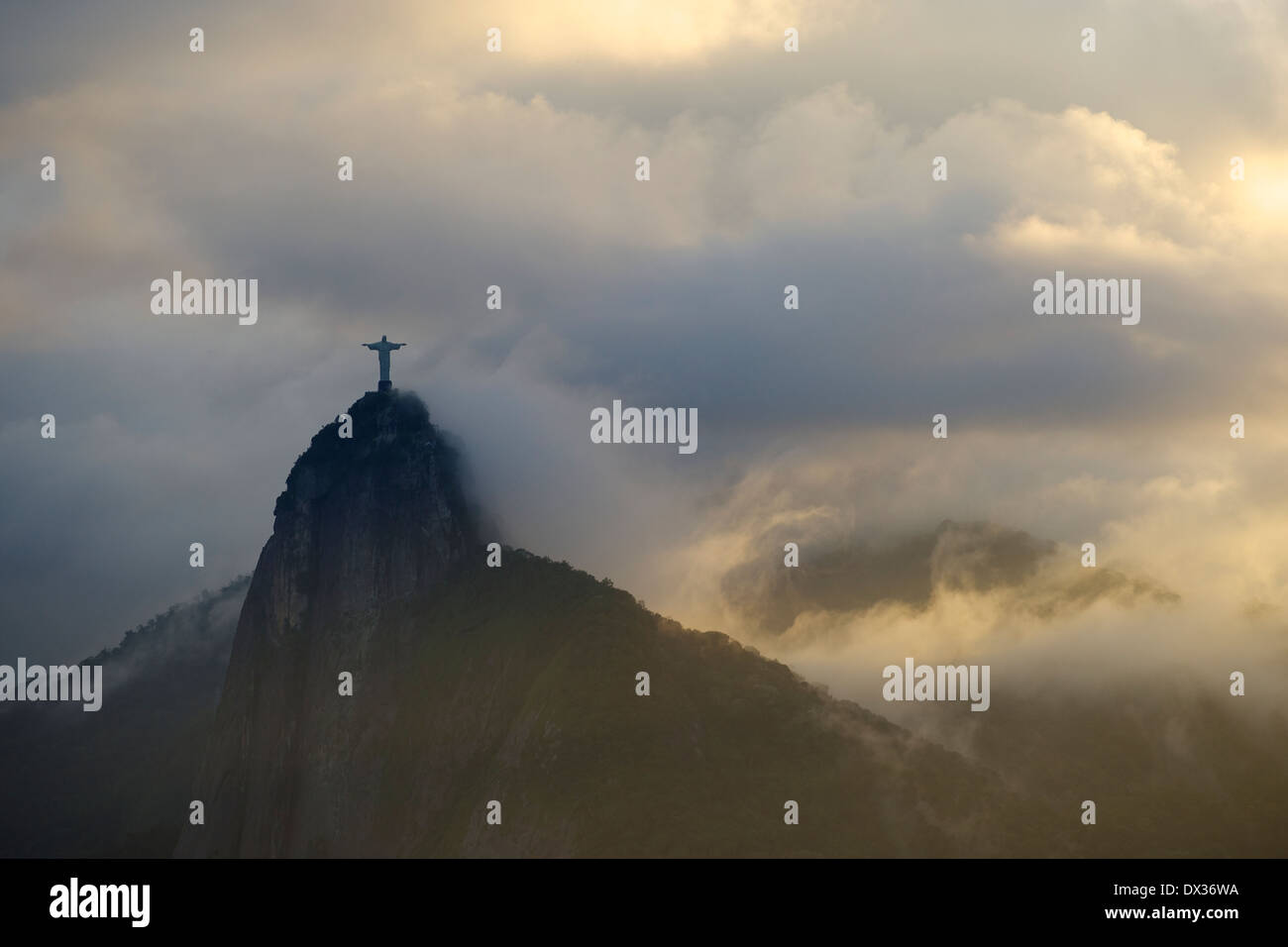 Christ the Redeemer statue appearing through the clouds on top of Corcovado mountain,Rio de Janeiro, Stock Photo
