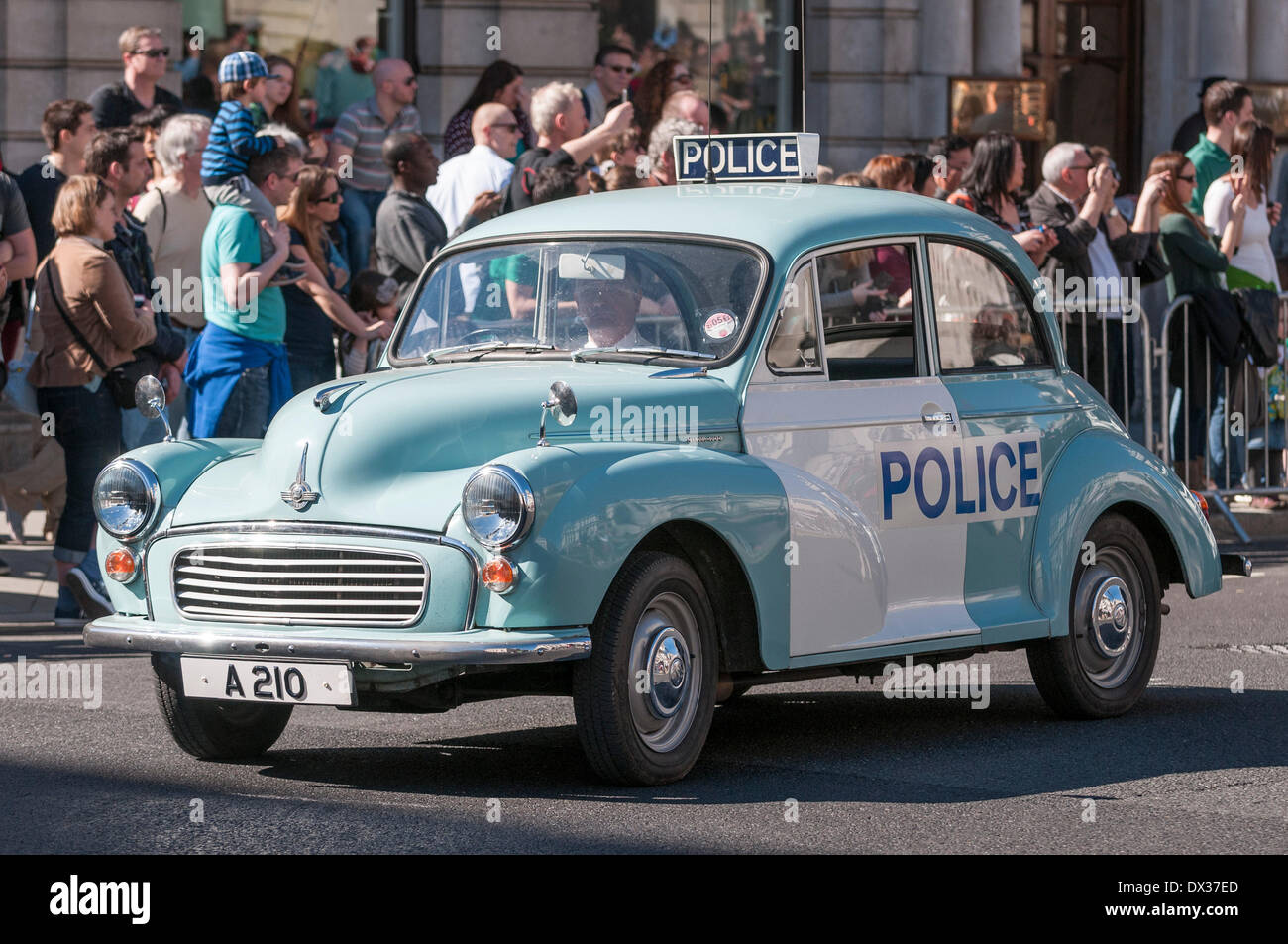 Waterloo Place, London, UK, 16 March 2014 - the annual St. Patrick's Day parade took place in bright sunshine in front of thousands of people who lined the route. A vintage Morris Minor police car takes place in the parade. Credit: Stephen Chung/Alamy Live News Stock Photo