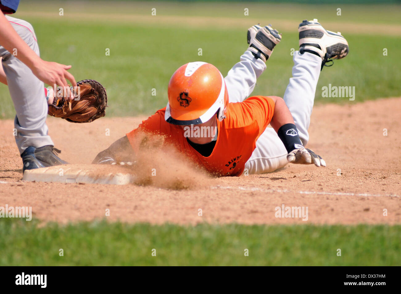 Sport Baseball Runner dives to first base ahead of a tag St. Charles Illinois Stock Photo