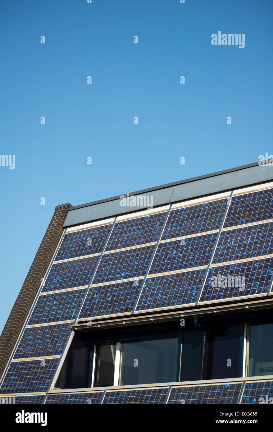 Solar panels on the roof of a house benefiting from renewable energy Stock Photo