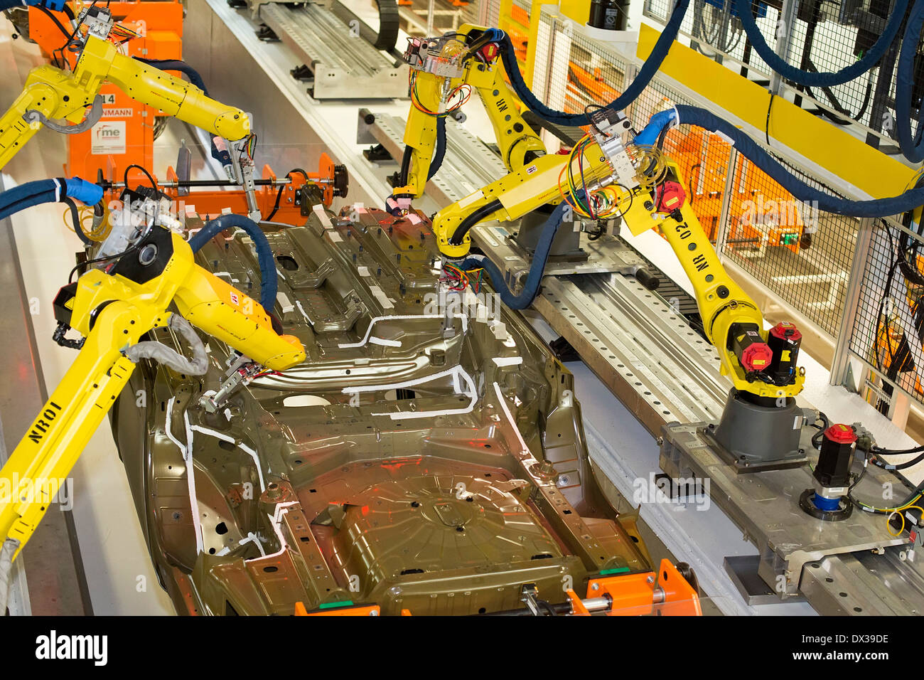 Robots in the underbody sealing and underbody coating station of the paint shop at Chrysler's Sterling Heights Assembly Plant. Stock Photo