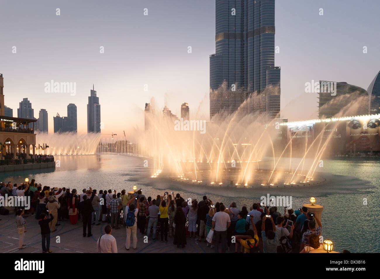People watching the Dubai fountain in front of the Burj Khalifa at sunset, Dubai Mall, UAE, United Arab Emirates Middle East Stock Photo