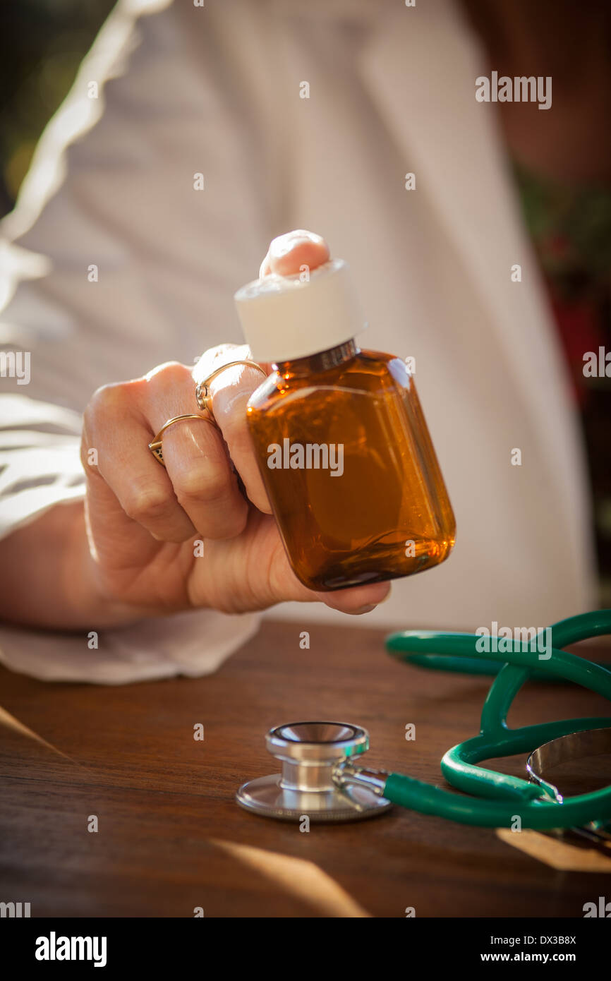 Close up of a Female doctor holding a medicine bottle Stock Photo