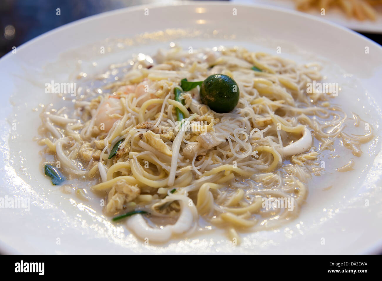 Hokkien Mee Stir Fry Noodles with Calamari Prawns Squid and Pork Closeup Stock Photo