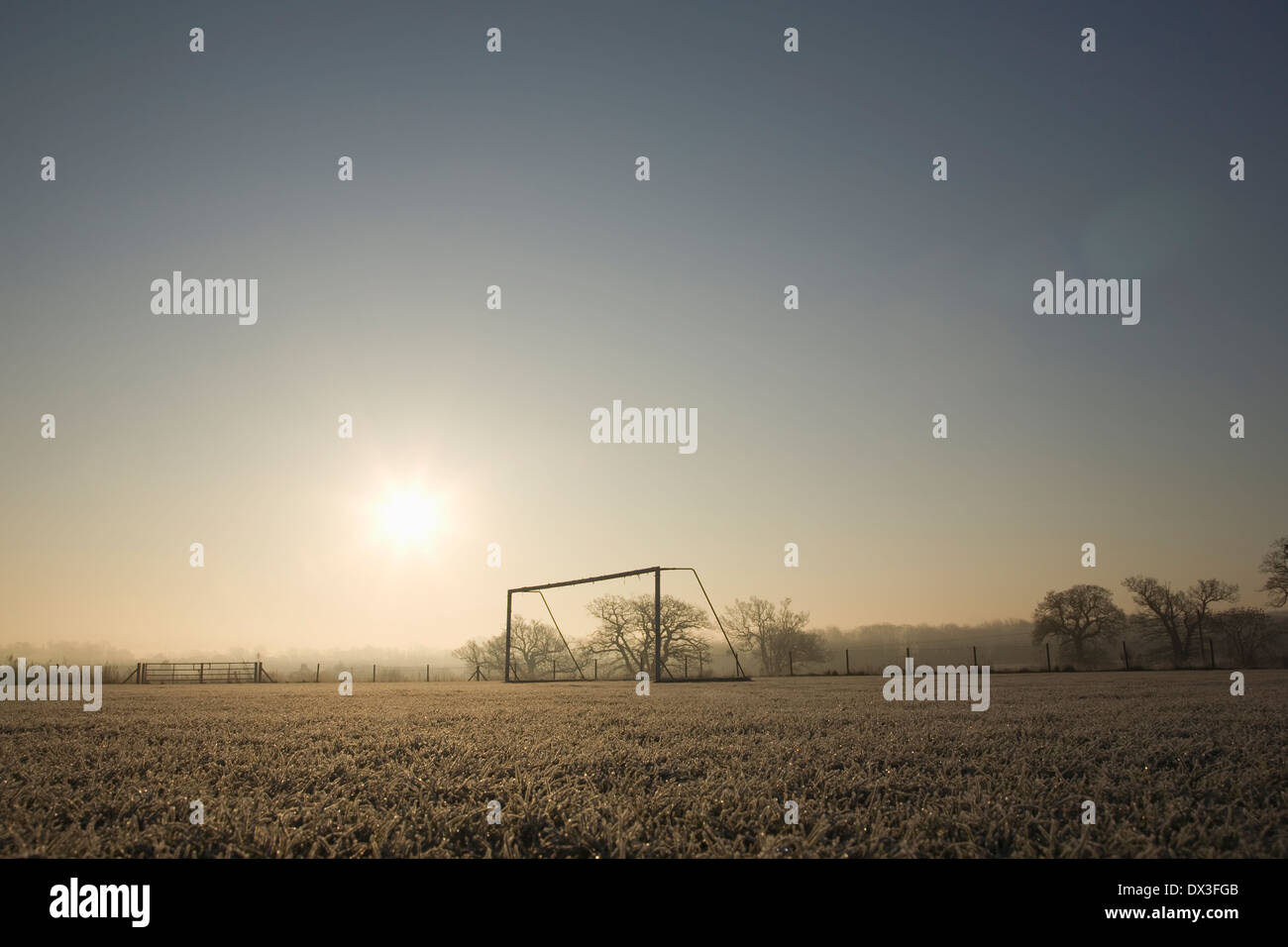 empty football pitch and goal on a frosty winter morning sunrise Stock Photo