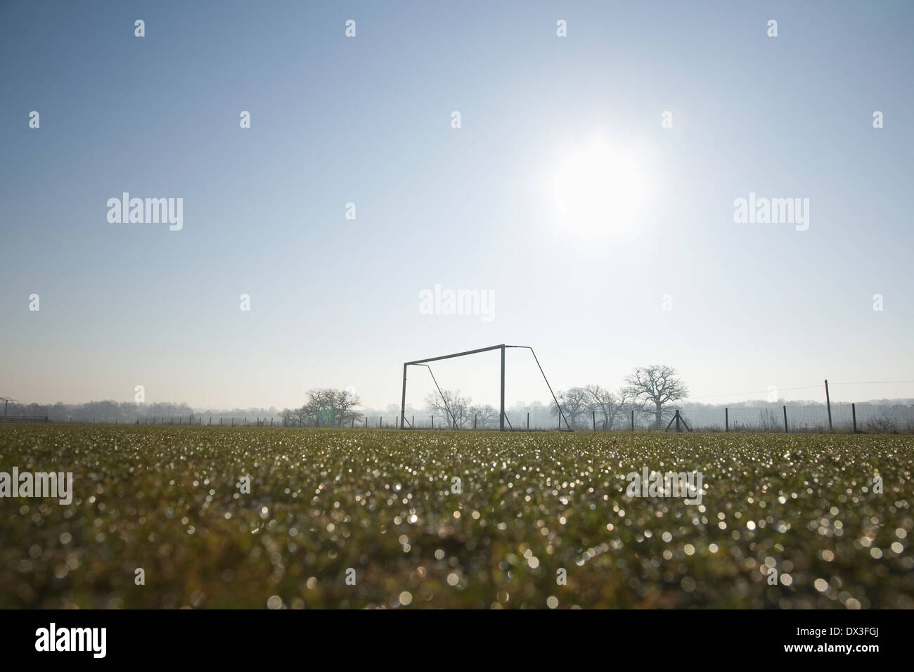 empty football pitch and goal on a frosty winter morning sunrise Stock Photo