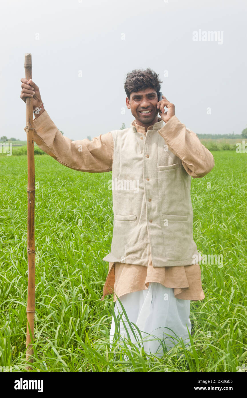 1 Indian Farmer Standing in Field and Talking with mobile Stock Photo ...