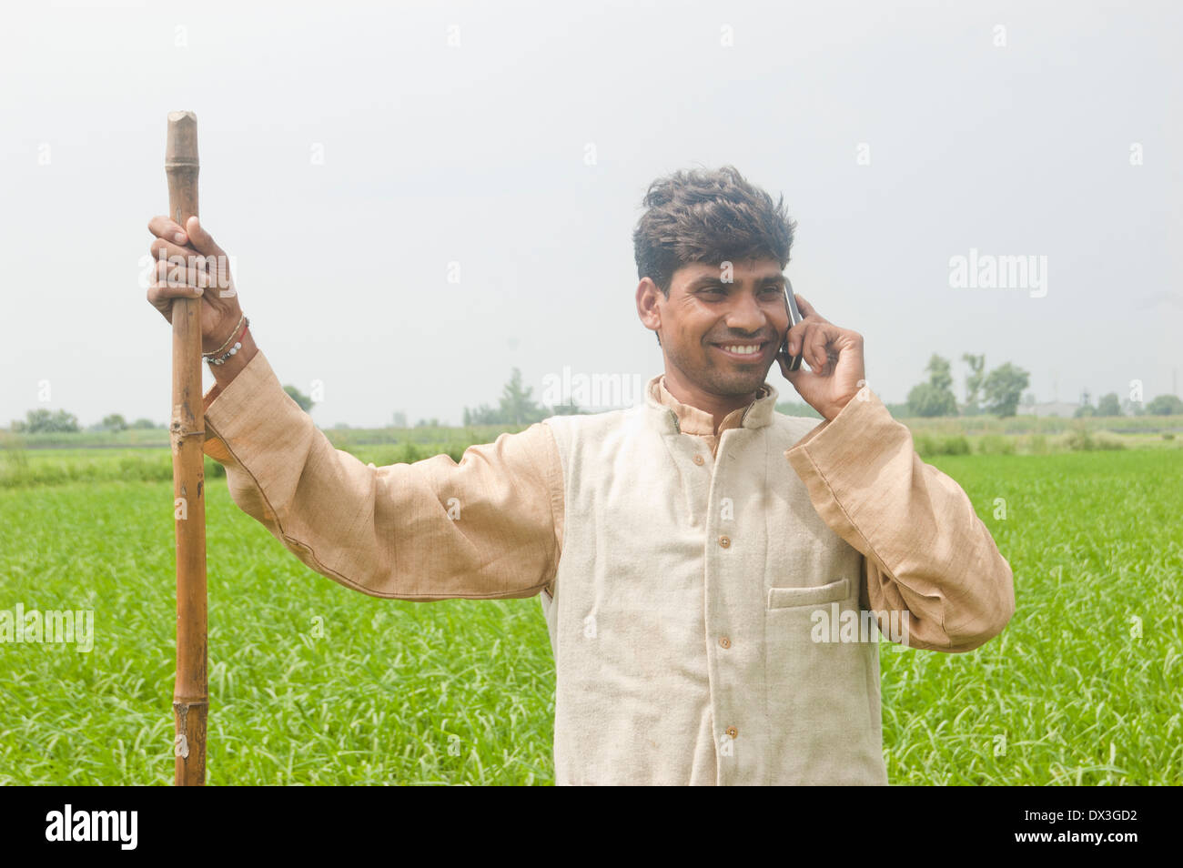 1 Indian Farmer Standing in Field and Talking with mobile Stock Photo ...