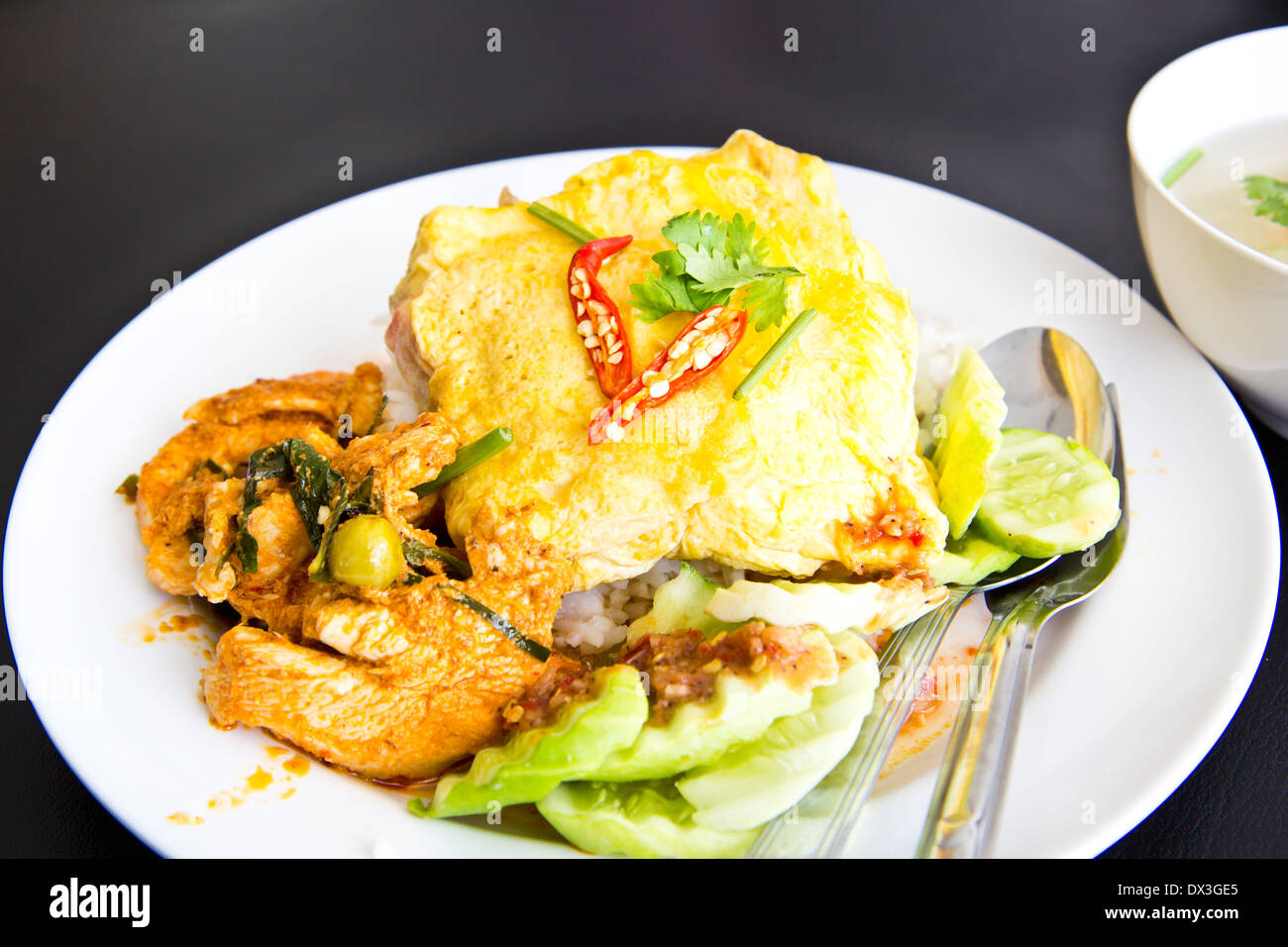Spicy chicken curry and omelet with jasmine rice Stock Photo