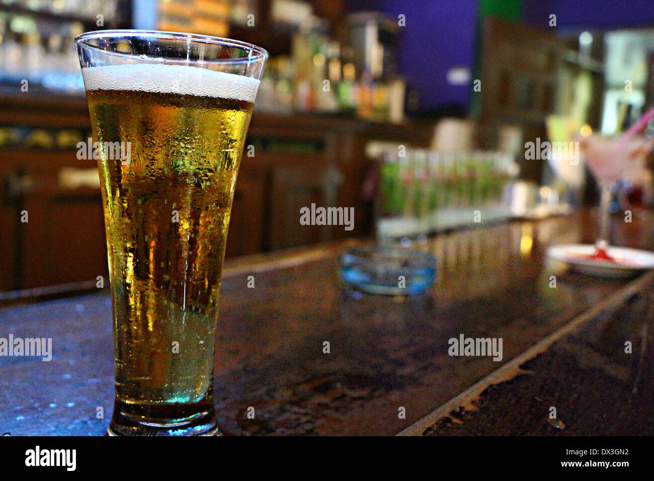 A cold beer on a wood bar let us see little condensation drops Stock ...