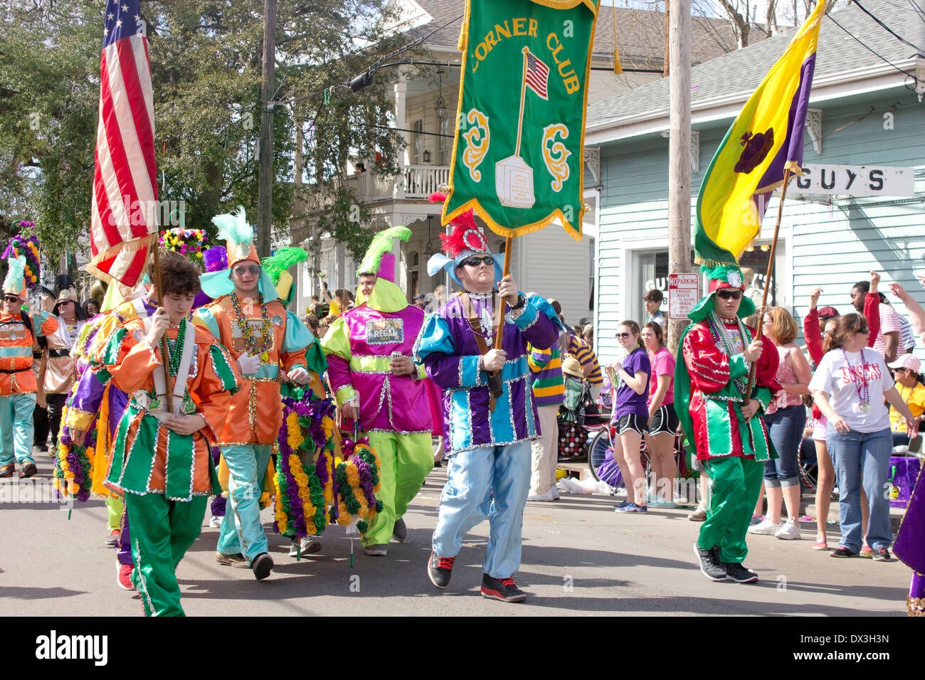 Corner Club marching group in costumes with flags.  Mardi Gras season New Orleans. Stock Photo