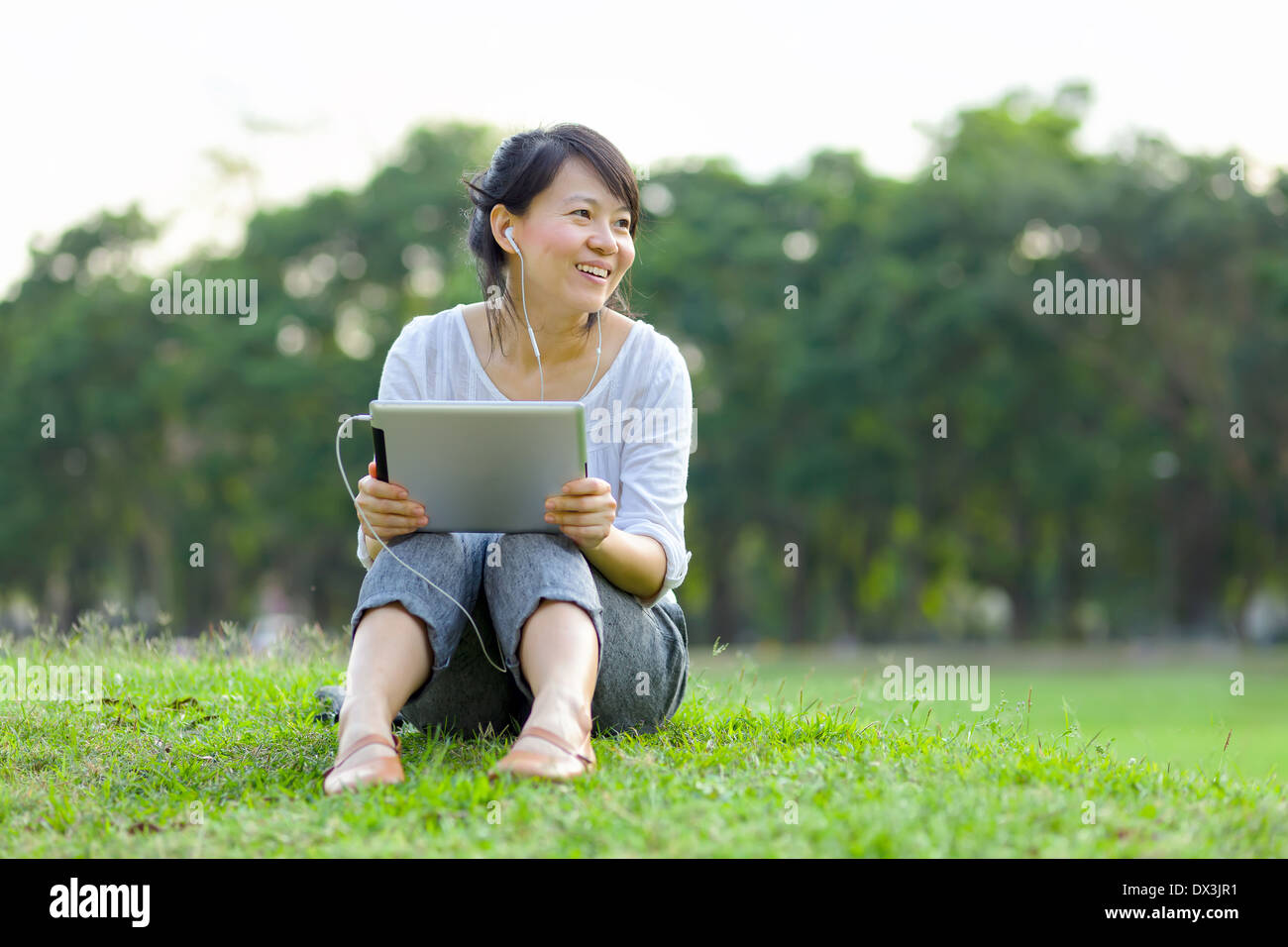 Asian woman headphones tablet hi-res stock photography and images - Alamy