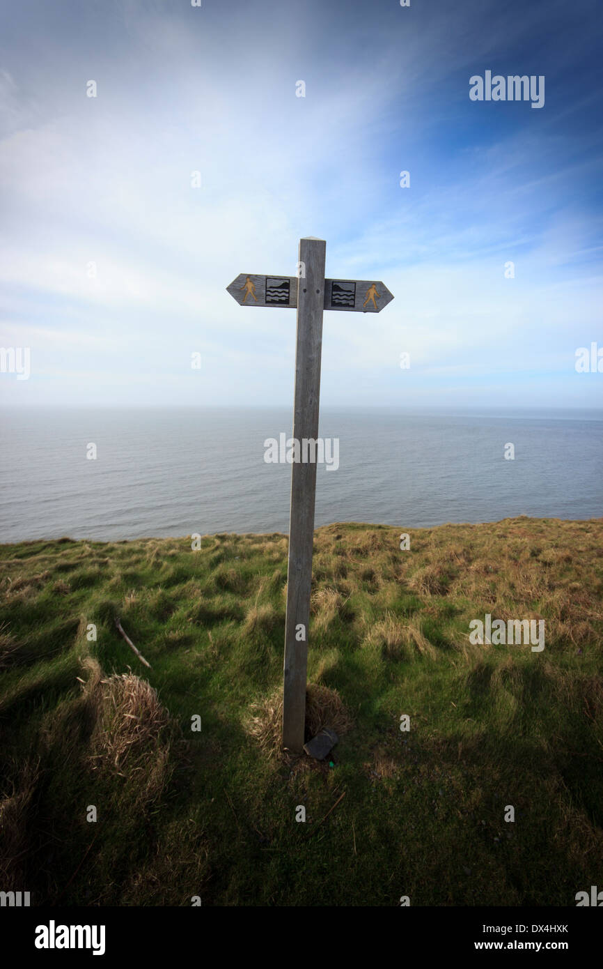 A direction signpost on top of a hill overlooking the sea in Aberystwyth, North Wales, United Kingdom. Stock Photo