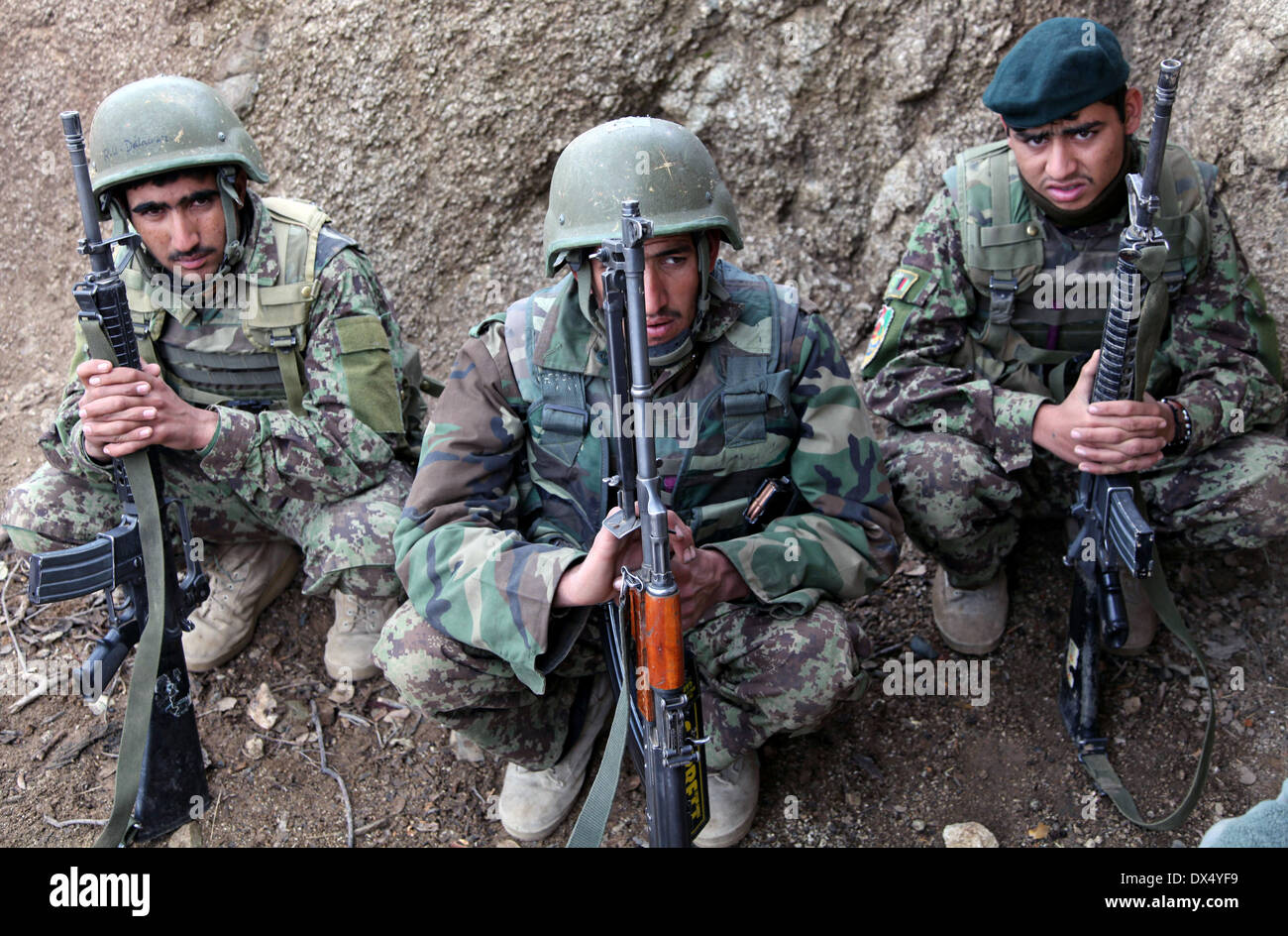 Afghan National Army soldiers take a break after a firefight with the Taliban March 29, 2011 in the valley of Barawala Kalet, Kunar province Afghanistan. Stock Photo