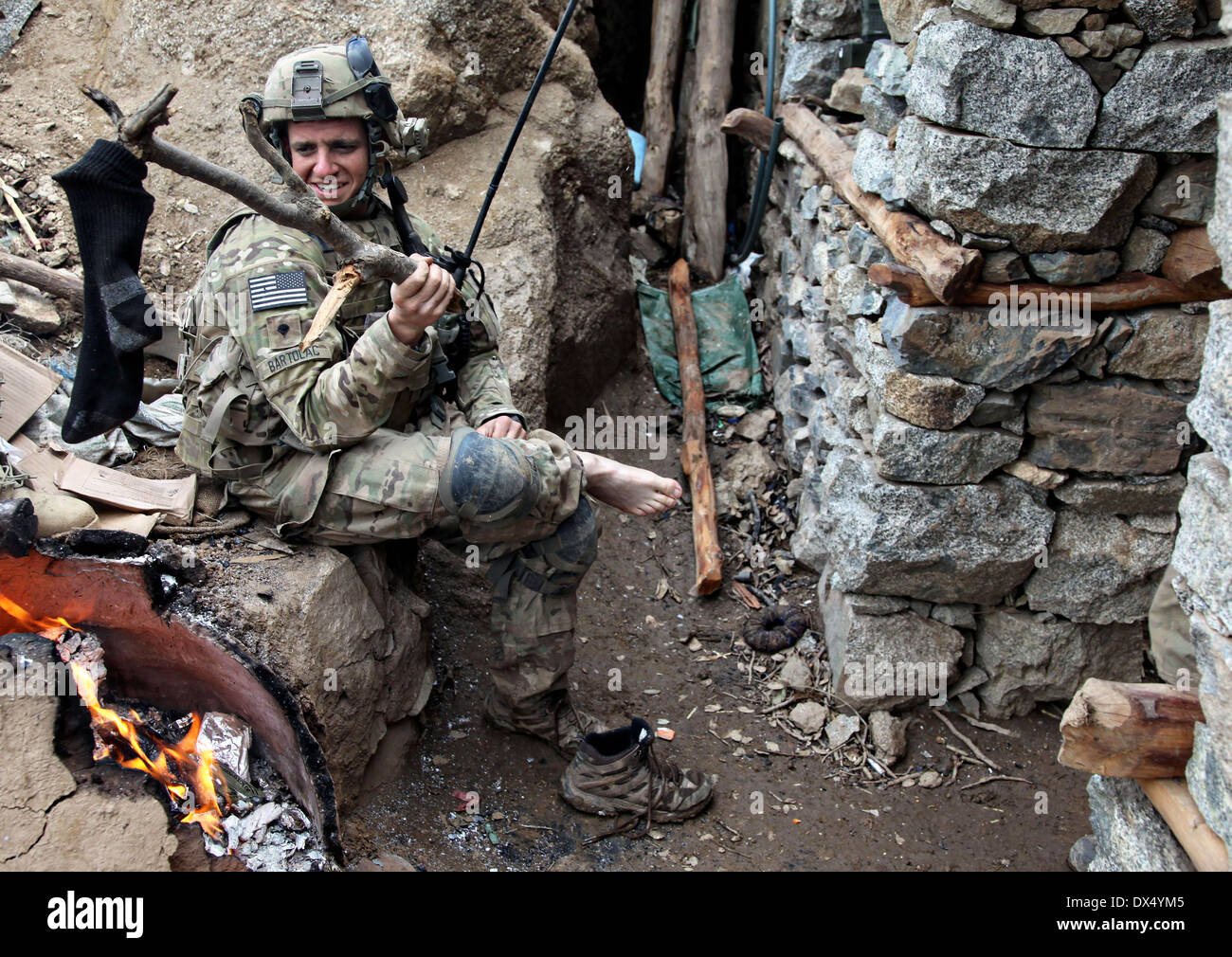 A US Army soldier with the 101st Airborne Division dries his socks after five days of battle against Taliban insurgents March 29, 2011 in the valley of Barawala Kalet, Kunar province Afghanistan. Stock Photo
