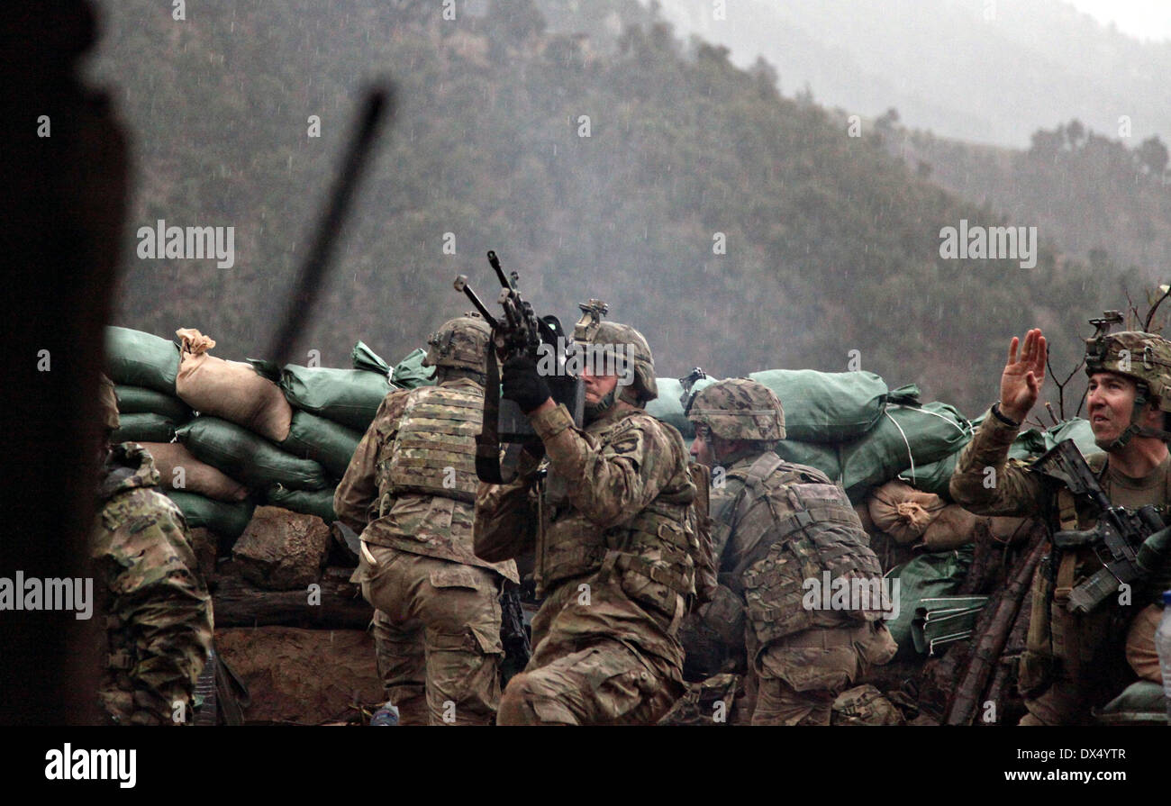 US Army soldiers with the 101st Airborne Division return fire during a firefight with the Taliban March 29, 2011 in the valley of Barawala Kalet, Kunar province Afghanistan. Stock Photo