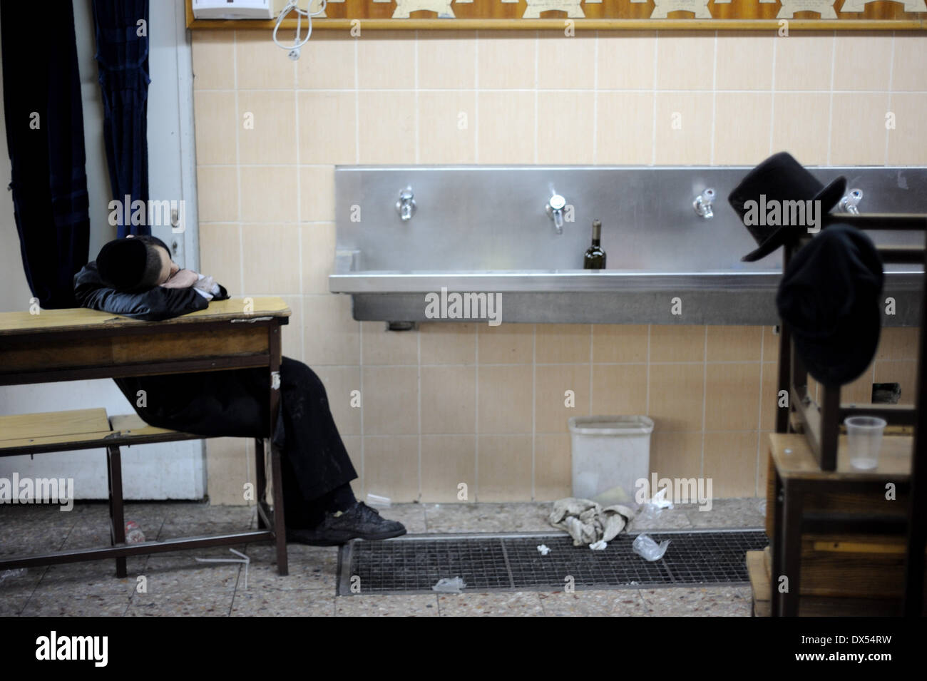 Jerusalem, Israel. 17th Mar, 2014. JERUSALEM, ISRAEL - MARCH 17, 2014: An Ultra-Orthodox Jewish is laing drunk during celebrations of Purim holiday in the ultra-orthodox Mea Shearim neighborhood in Jerusalem on March 17, 2014. The festival of Purim commemorates the rescue of Jews from a genocide in ancient Persia. Credit:  Gili Yaari/NurPhoto/ZUMAPRESS.com/Alamy Live News Stock Photo