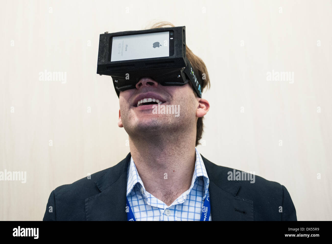 London, UK. 18 March 2014. A man wears vrAse augmented reality oculars