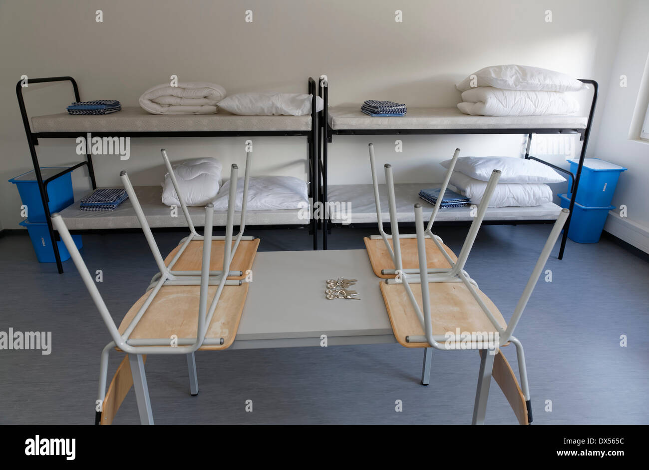 Chairs on a table, bunk beds, container for asylum