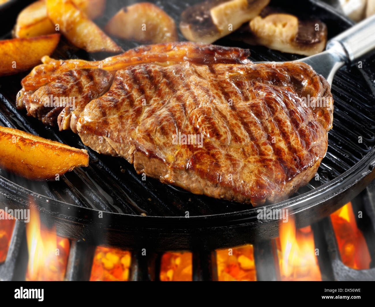 Sirloin beef steaks & chips being pan fried on a bbq. Meat food photos
