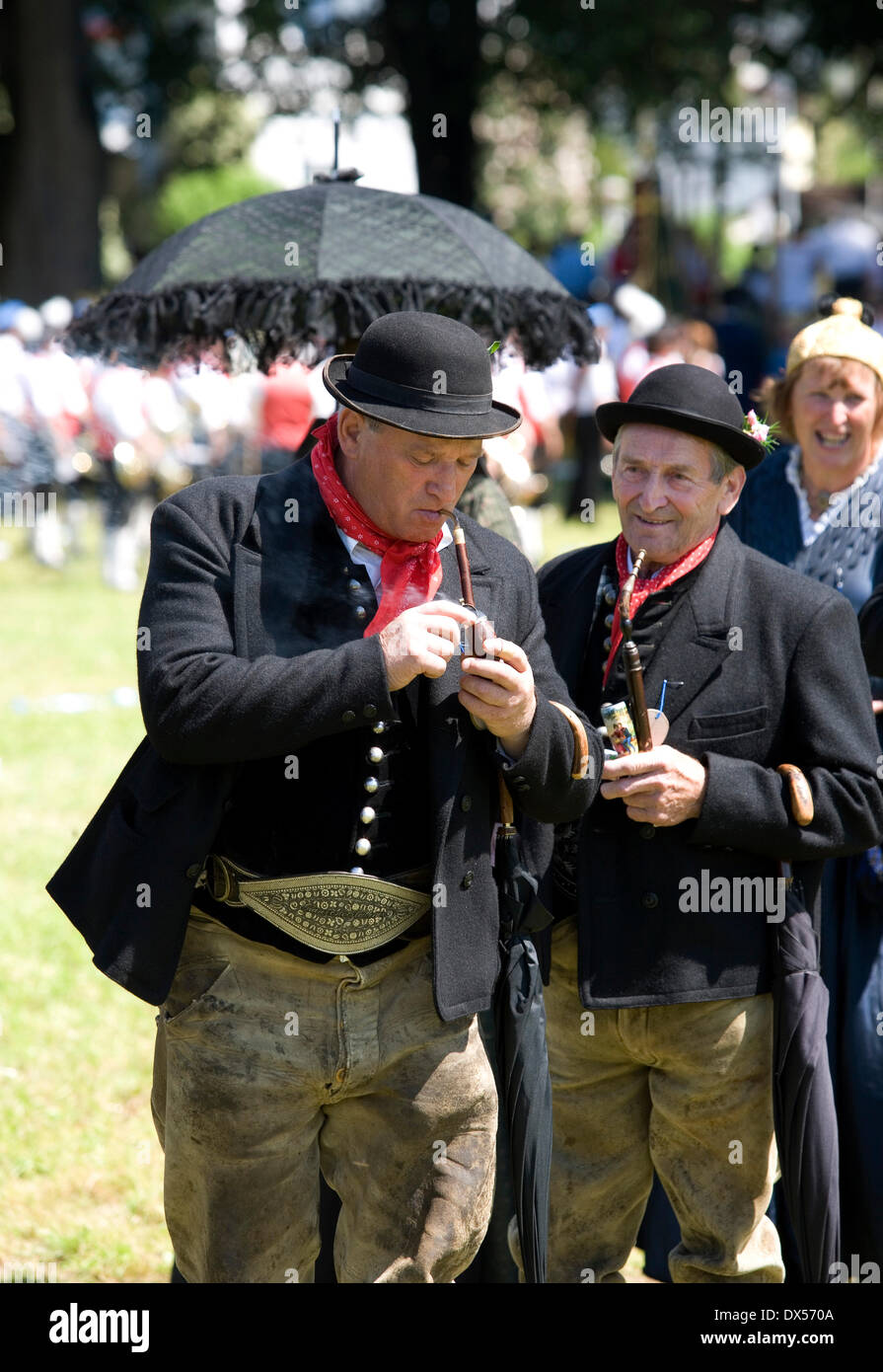 Men wearing traditional costumes, smoking a pipe, Mondsee