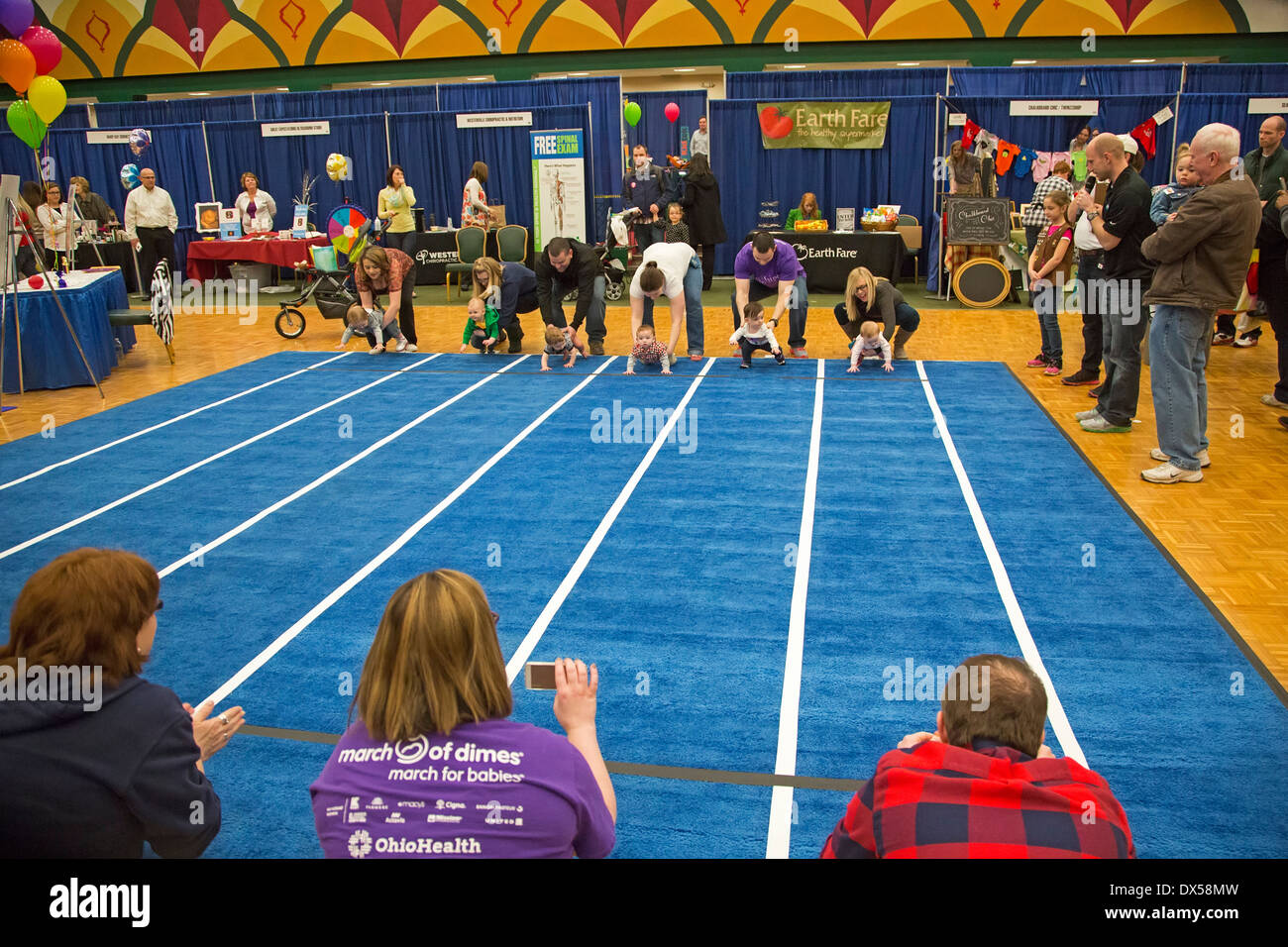 Babies compete in a Diaper Derby race Stock Photo