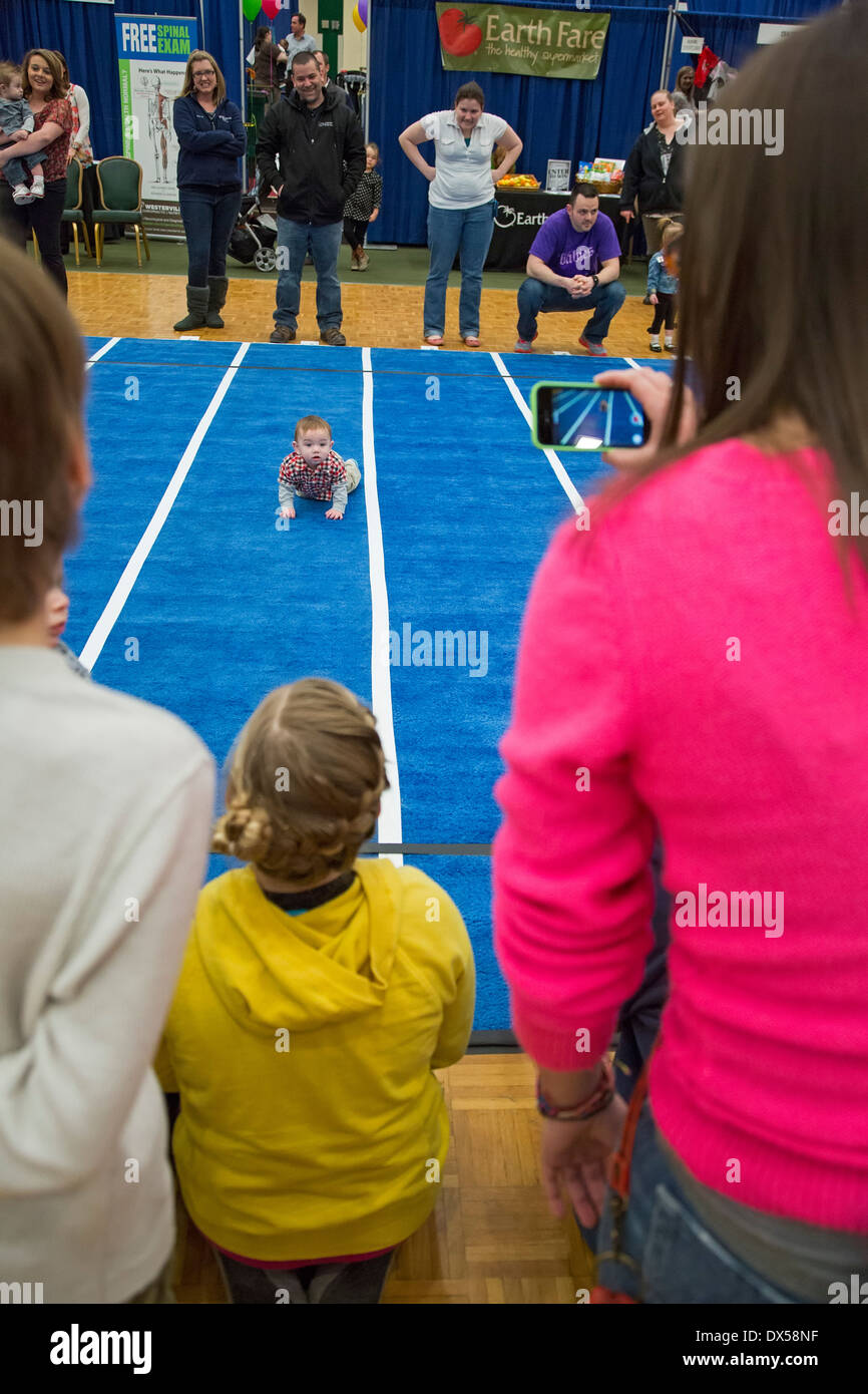 Babies compete in a Diaper Derby race Stock Photo