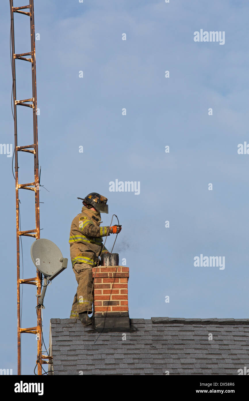 Kenton, Ohio - A firefighter fights a chimney fire in a rural house. Stock Photo
