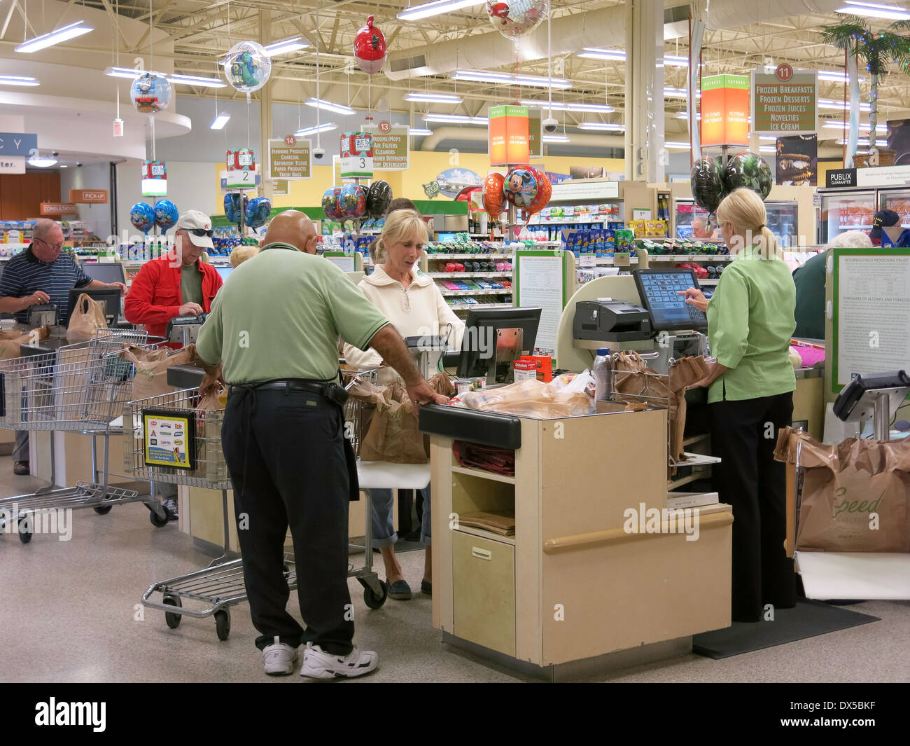 Shoppers at Check Out Stand with Cashier,  Publix Super Market in Flagler Beach, Florida Stock Photo