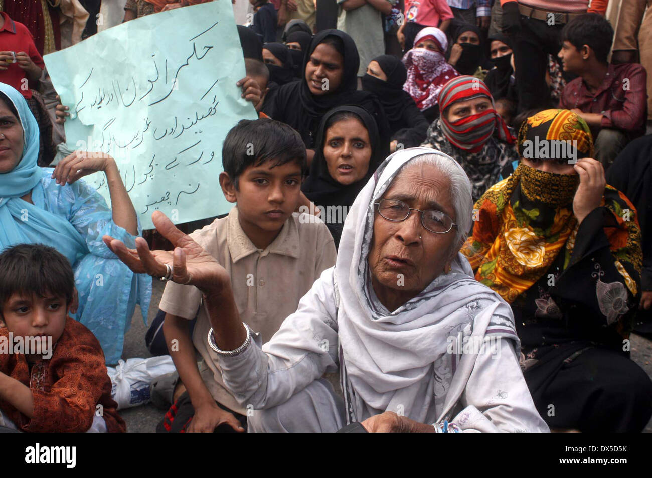 Residents of Liaquatabad, Shaheed Chowk Area are protesting against influential people who are suppressing them to vacant their living place where they are settling for last forty years, during a demonstration at Karachi press club on Tuesday, March 18, 2014. Stock Photo