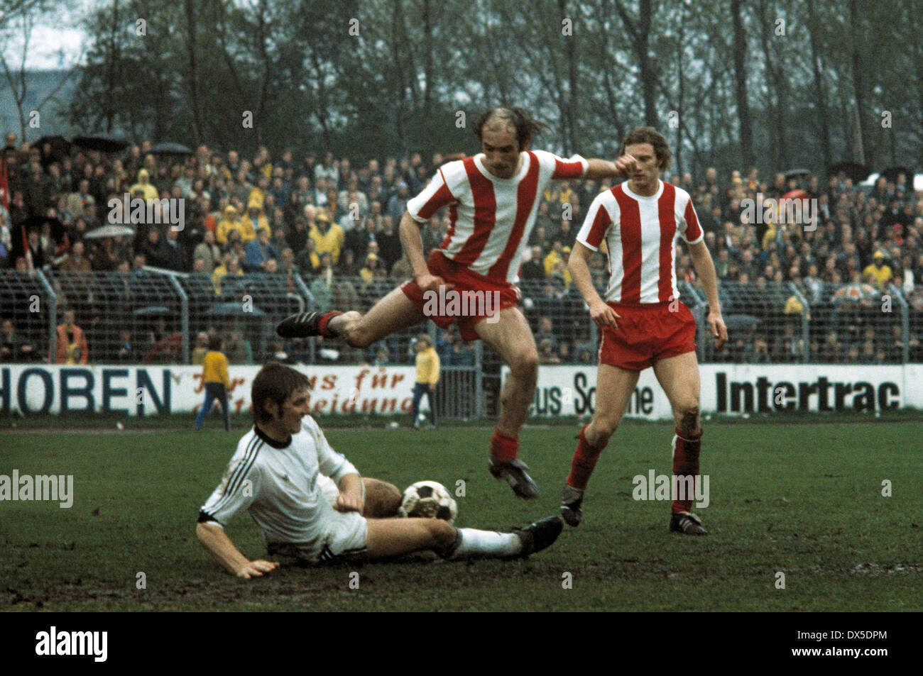 football, 2. Bundesliga Nord, 1974/1975, Lohrheide Stadium, SG Wattenscheid 09 versus Fortuna Cologne 0:0, scene of the match, f.l.t.r. Rudi Klimke (09), Johannes Linssen (Koeln), Lothar Wesseler (Koeln) Stock Photo