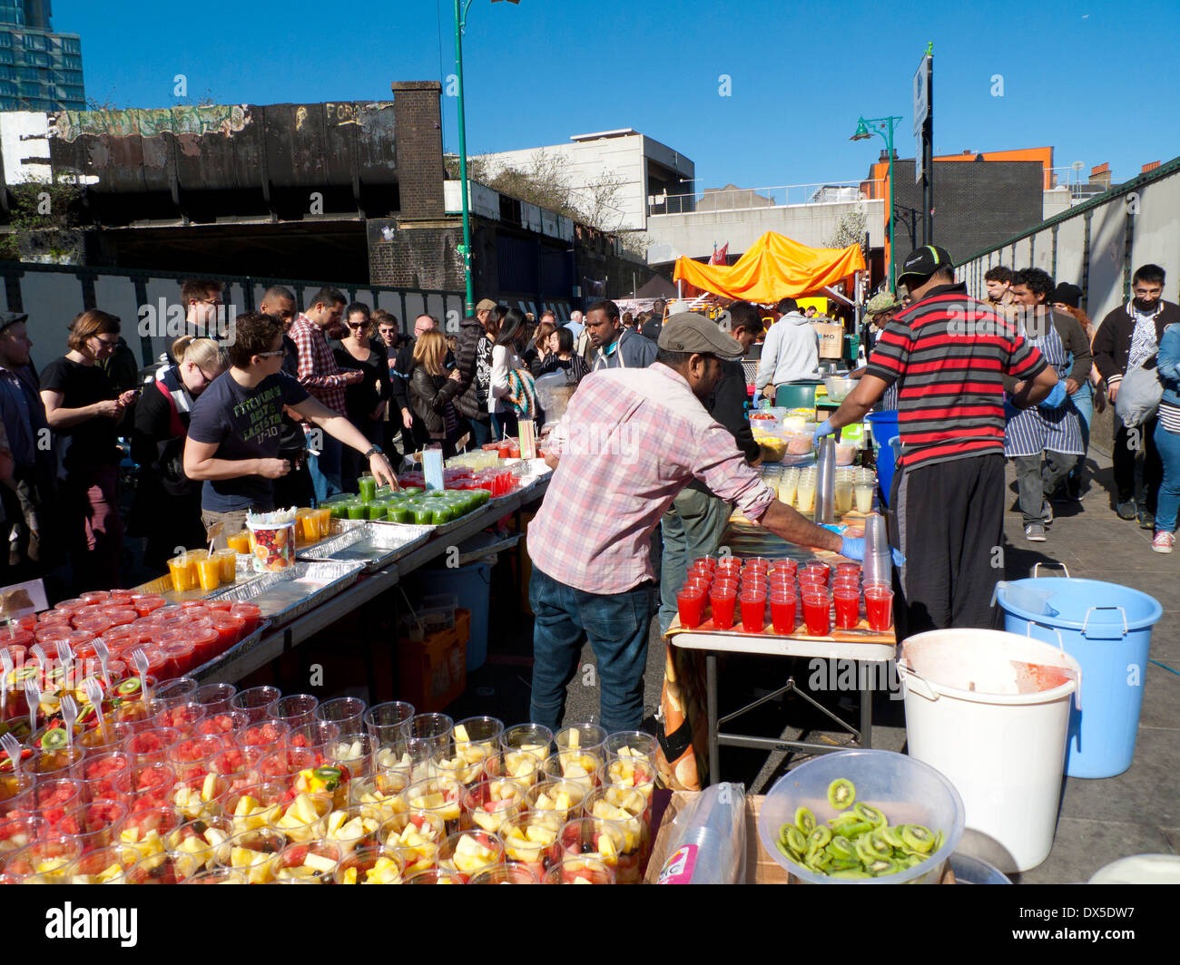Fruit sellers selling fruit in cups and smoothies at Brick Lane street