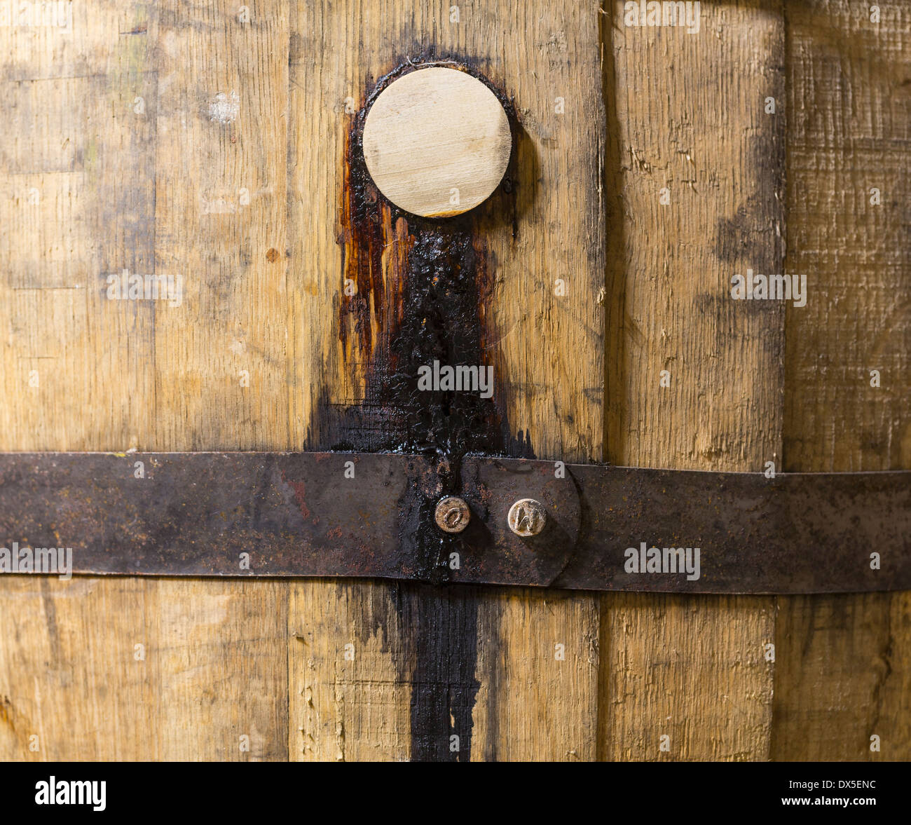 Wooden bung or cork in an old bourbon whisky barrel in a cellar Stock Photo