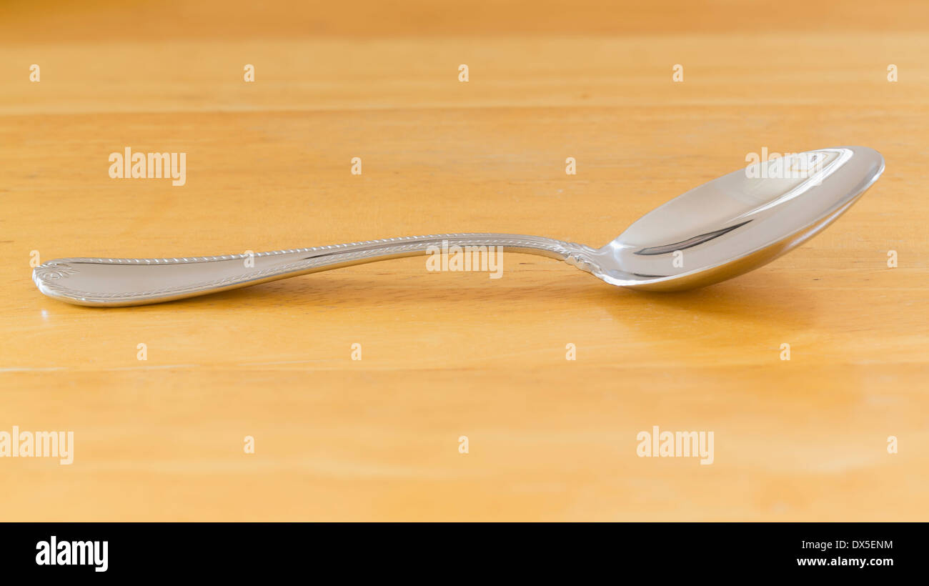 Spoon on wooden table, cutlery Stock Photo