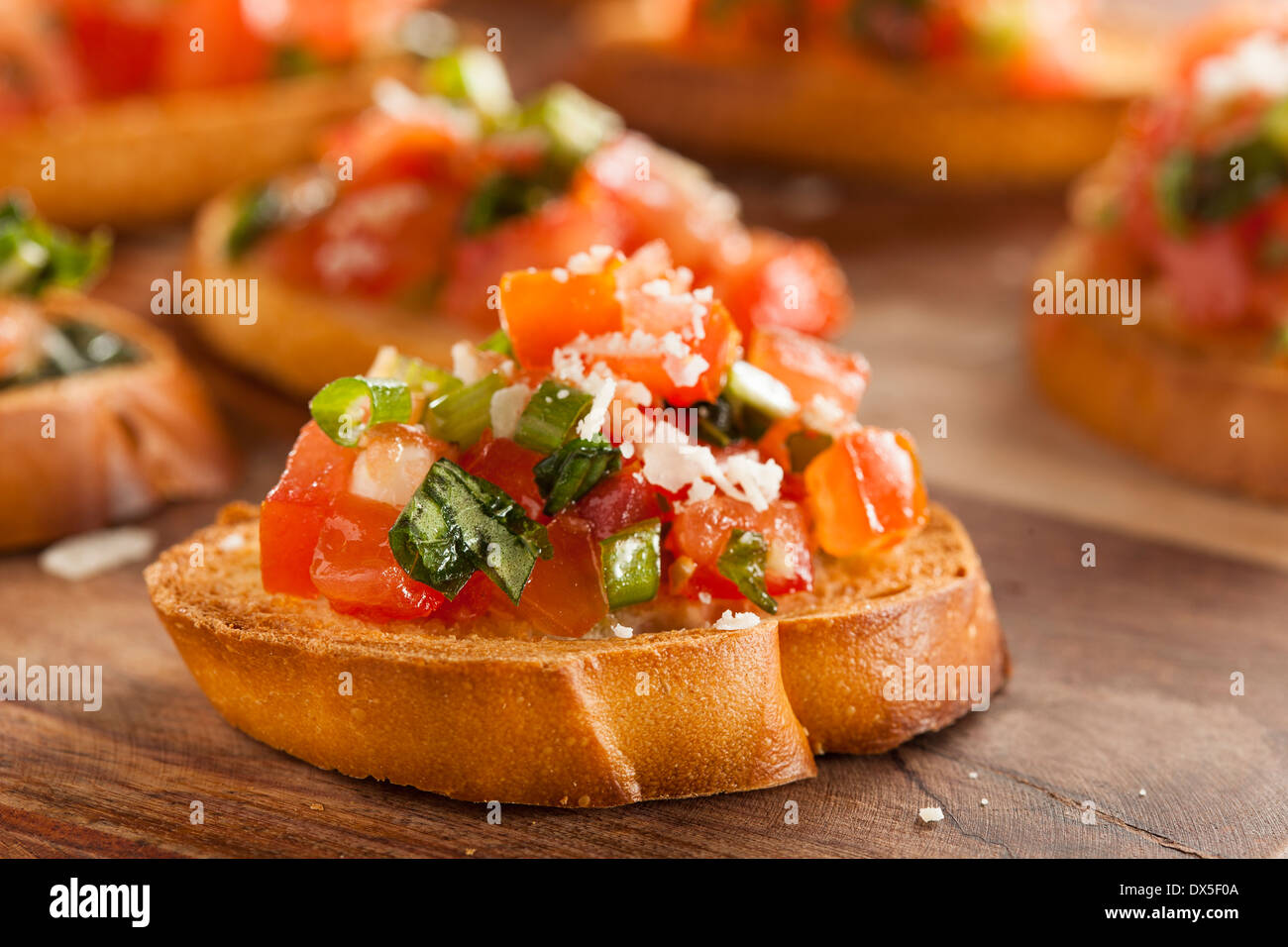 Homemade Italian Bruschetta Appetizer with Basil and Tomatoes Stock Photo