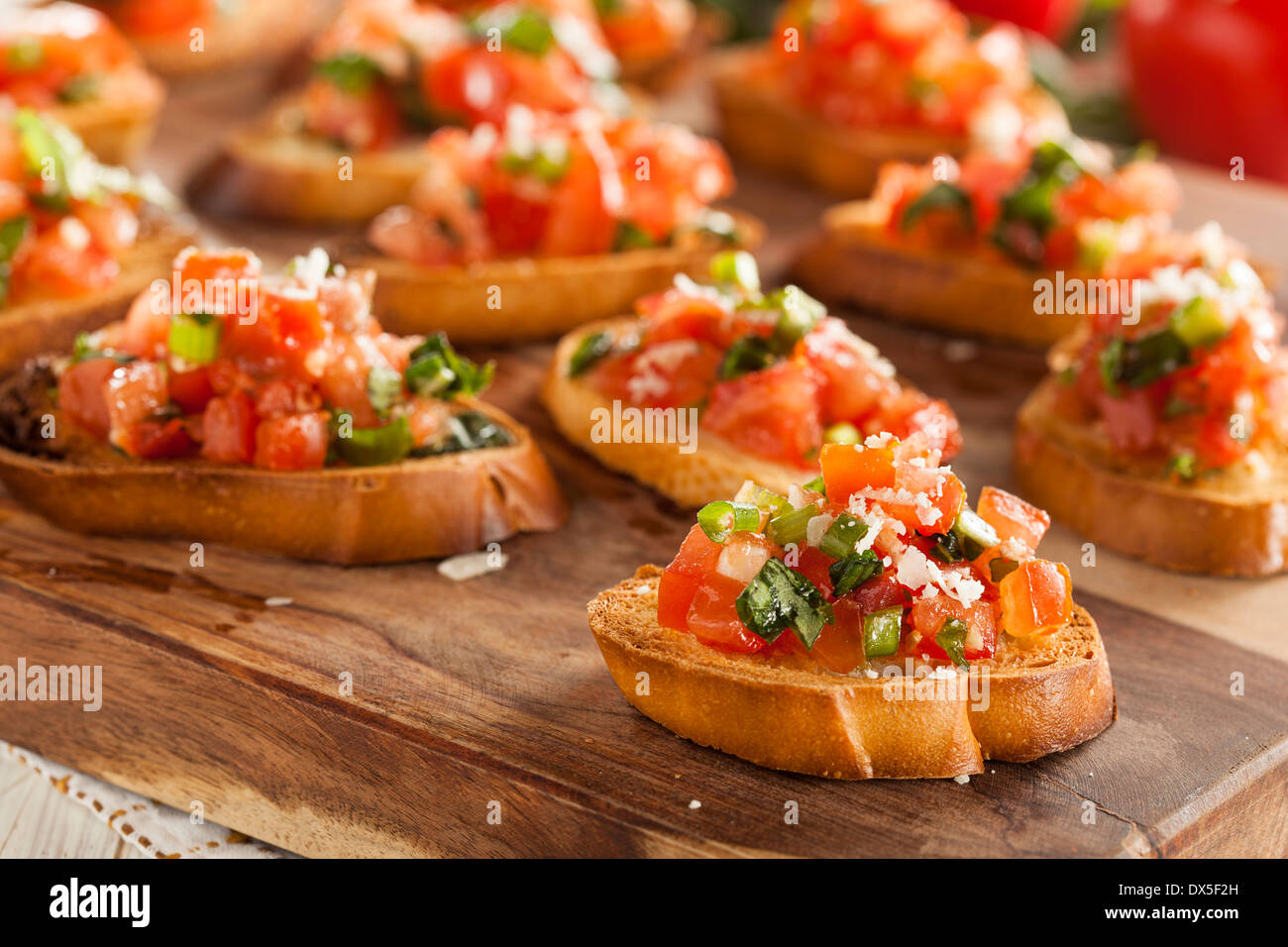 Homemade Italian Bruschetta Appetizer with Basil and Tomatoes Stock Photo