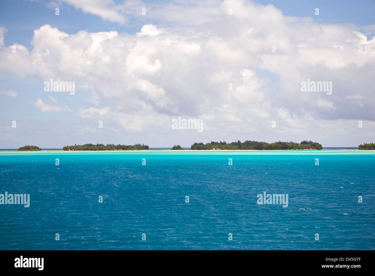 Tahitian blue ocean seascape under blue sky with clouds Stock Photo