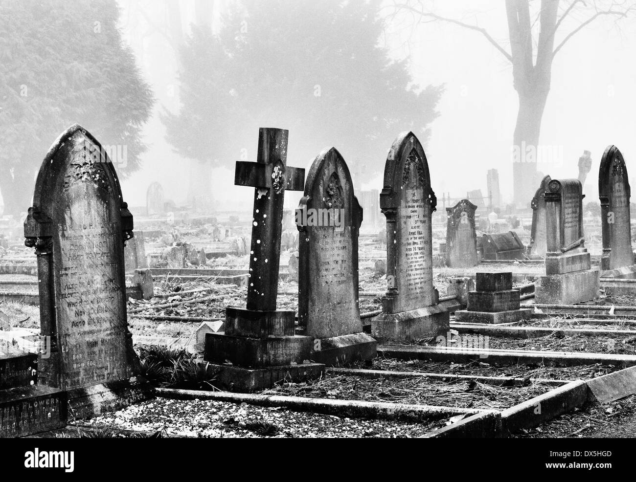 Gravestones in the fog at Banbury Cemetery, Oxfordshire, England. Monochrome Stock Photo