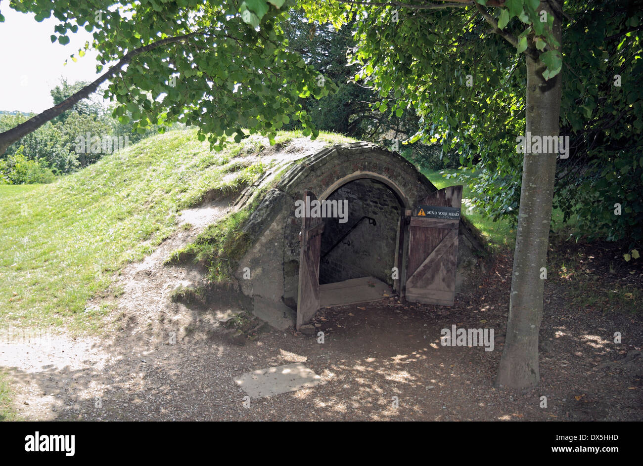 Entrance to a 17th century icehouse with turf roof on the site of the Battle of Hastings, Battle, East Sussex, UK. Stock Photo