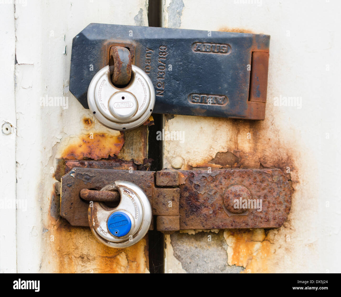 2 rusty round padlocks on an outside building. Stock Photo