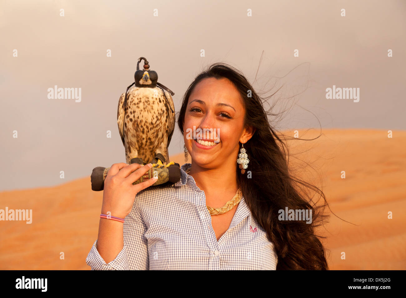 Female tourist with a tame falcon, Arabian desert safari, Dubai, UAE, United Arab Emirates Middle East Stock Photo