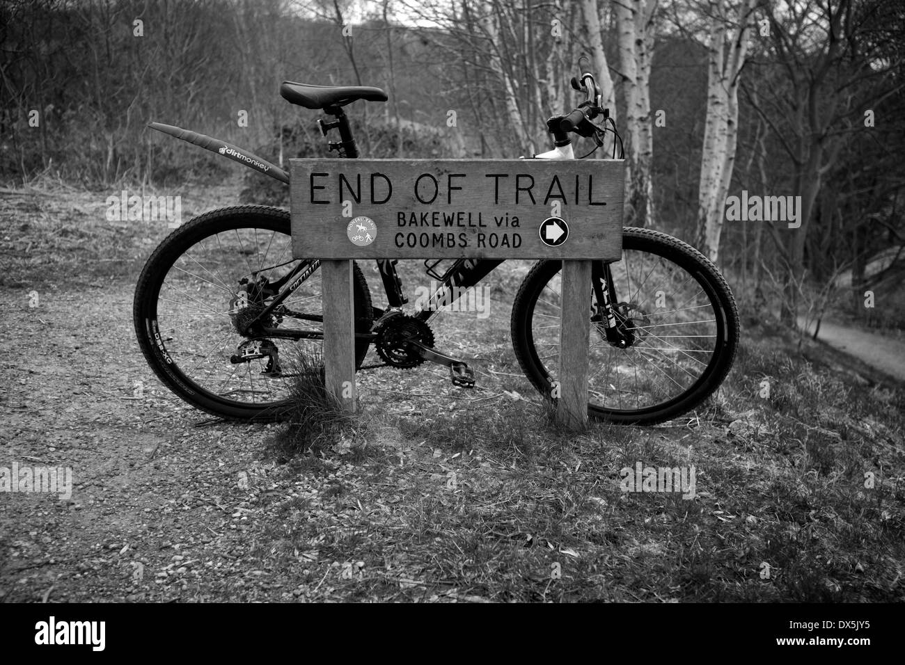 A mountain bike rests on a sign at the end of the Monsal Trail in Derbyshire. Stock Photo