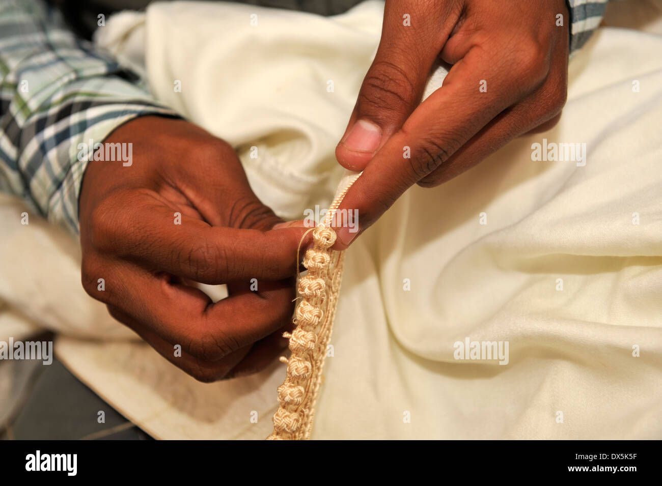 Close-up details of traditional hand stitching the traditional  kaftan robe, Marrakech, Morocco Stock Photo