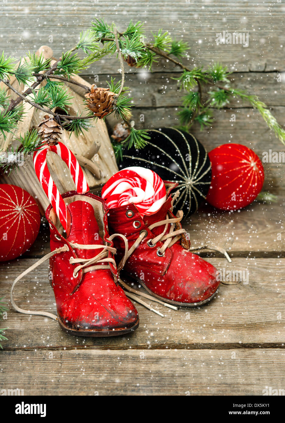 christmas stocking. nostalgic decoration with antique toys and vintage baby shoes over wooden background. Stock Photo