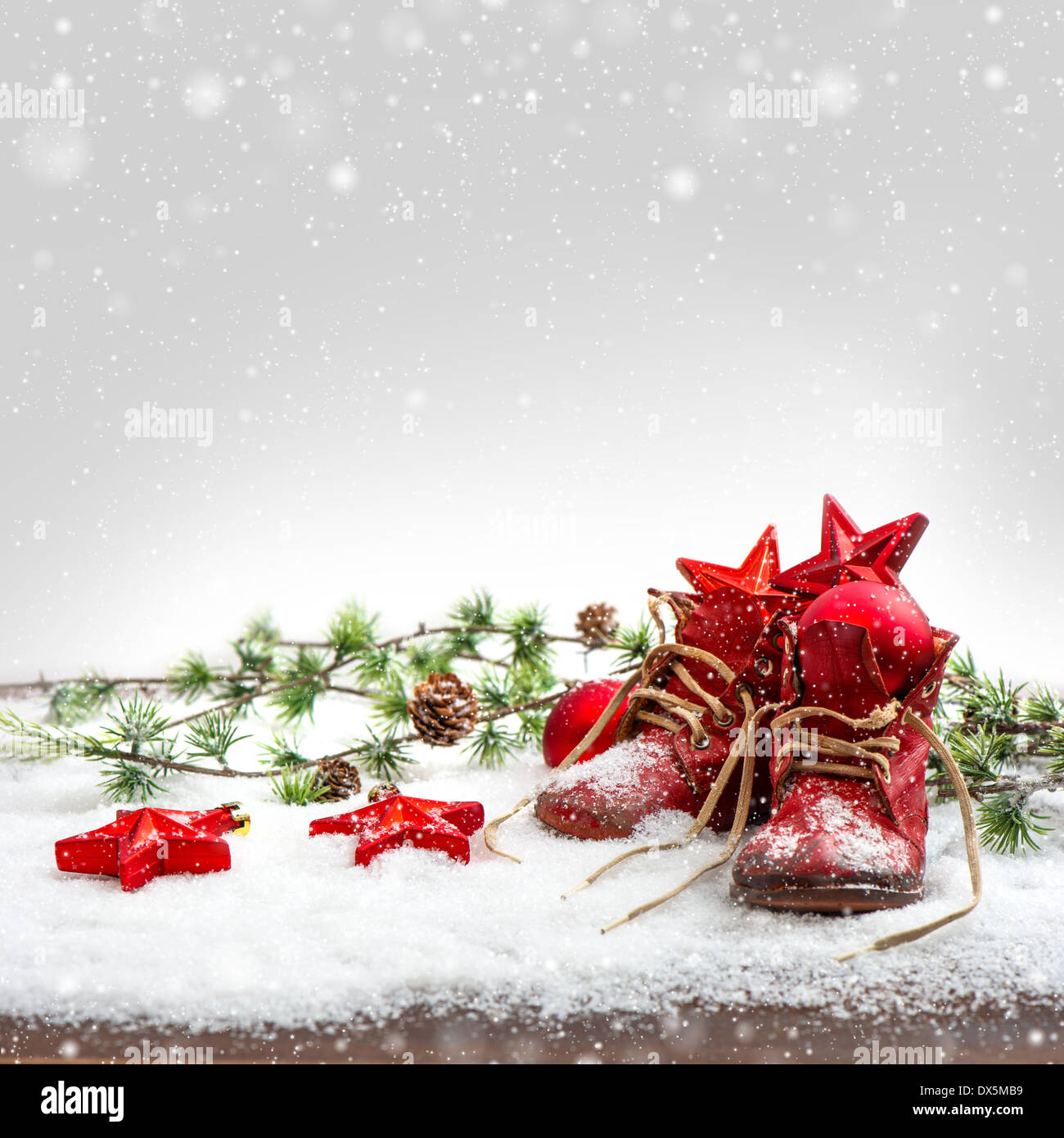 nostalgic christmas decoration with antique baby shoes. festive background. retro style picture with snow effect Stock Photo