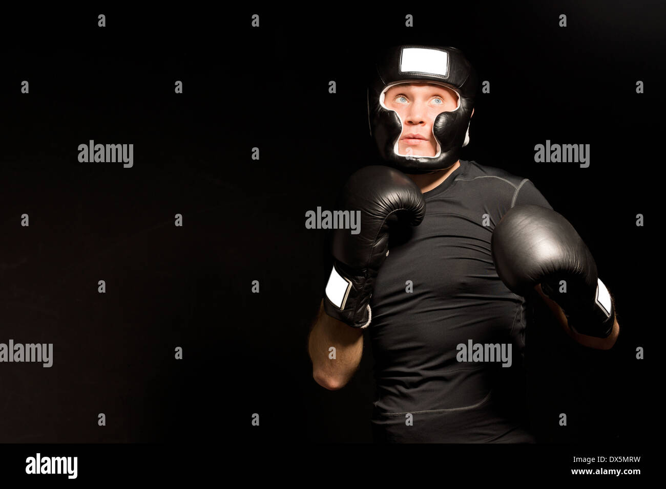 Determined young boxer with his fists at the ready Stock Photo - Alamy