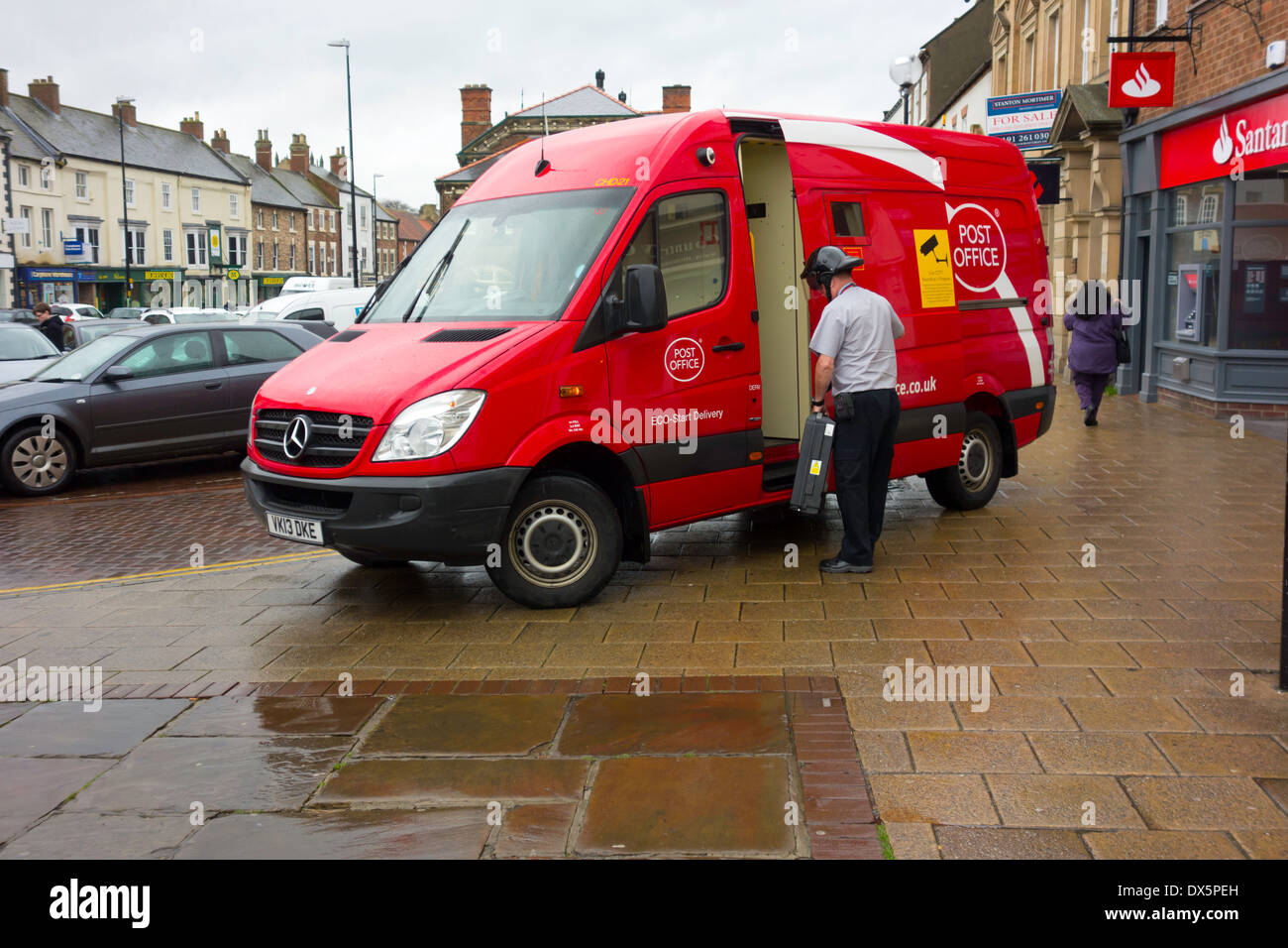 A Post Office van with driver wearing a 